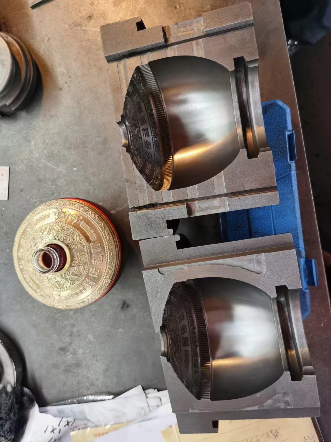 Ball decanter mould halves next to the first fired sample – shape matches perfectly