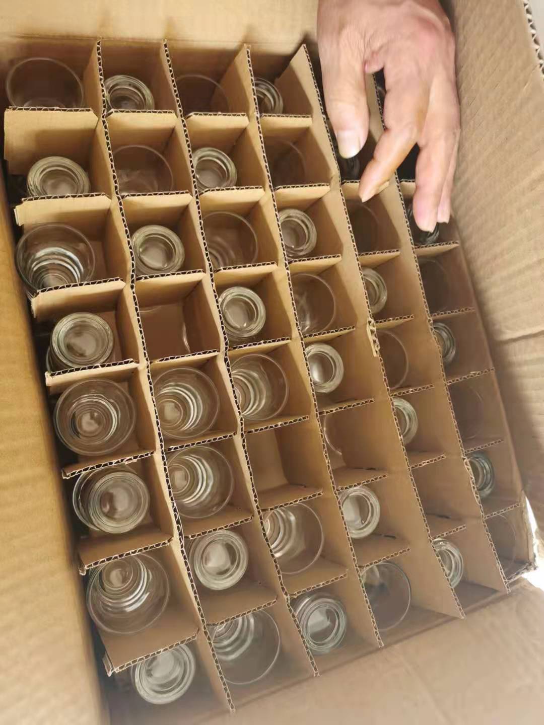 Glass decanters and tasting cups packed in one divider box