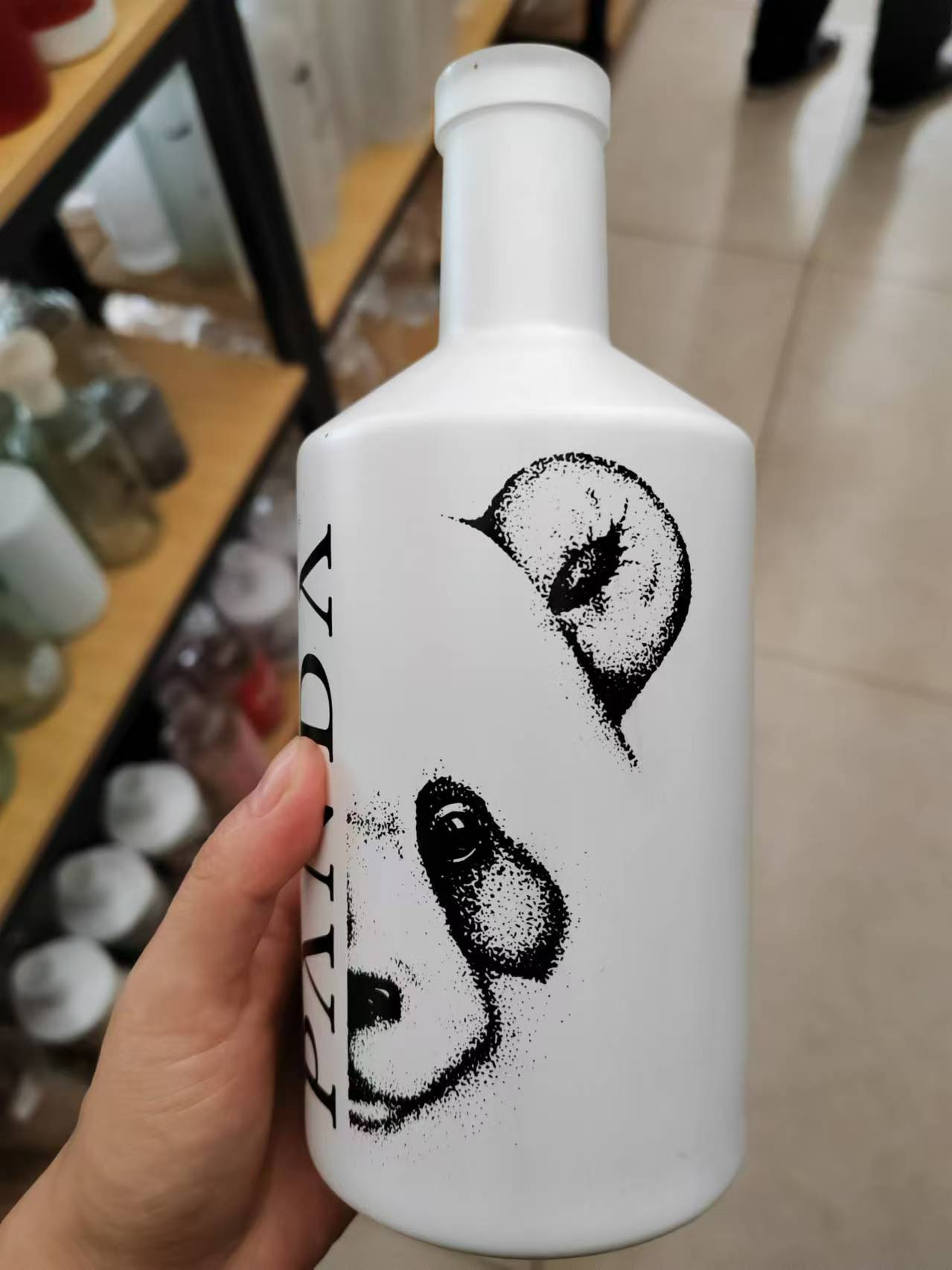 Full wrap fired decal on a matte black vodka bottle