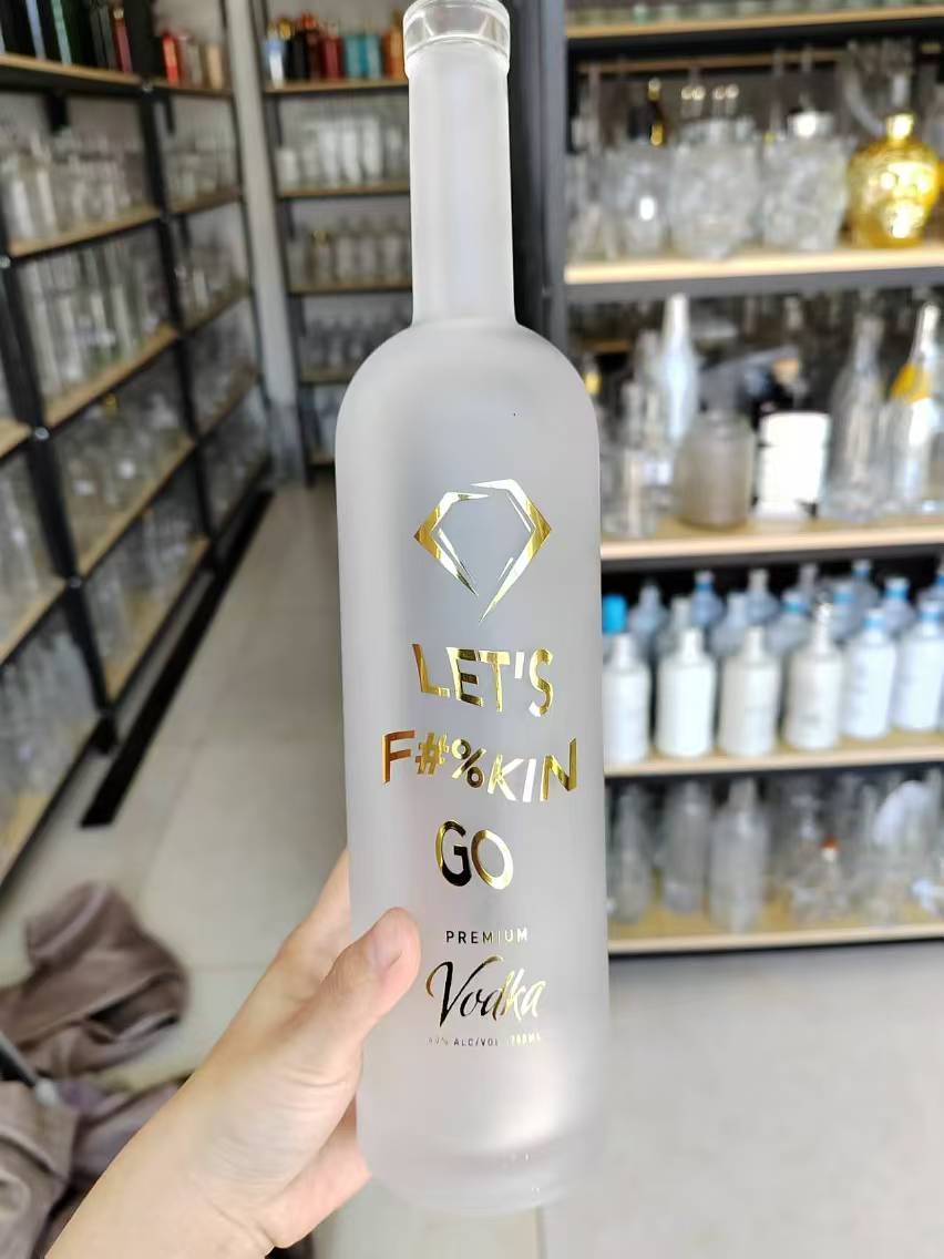 Acid-etched frosted vodka bottle with gold screen printed artwork