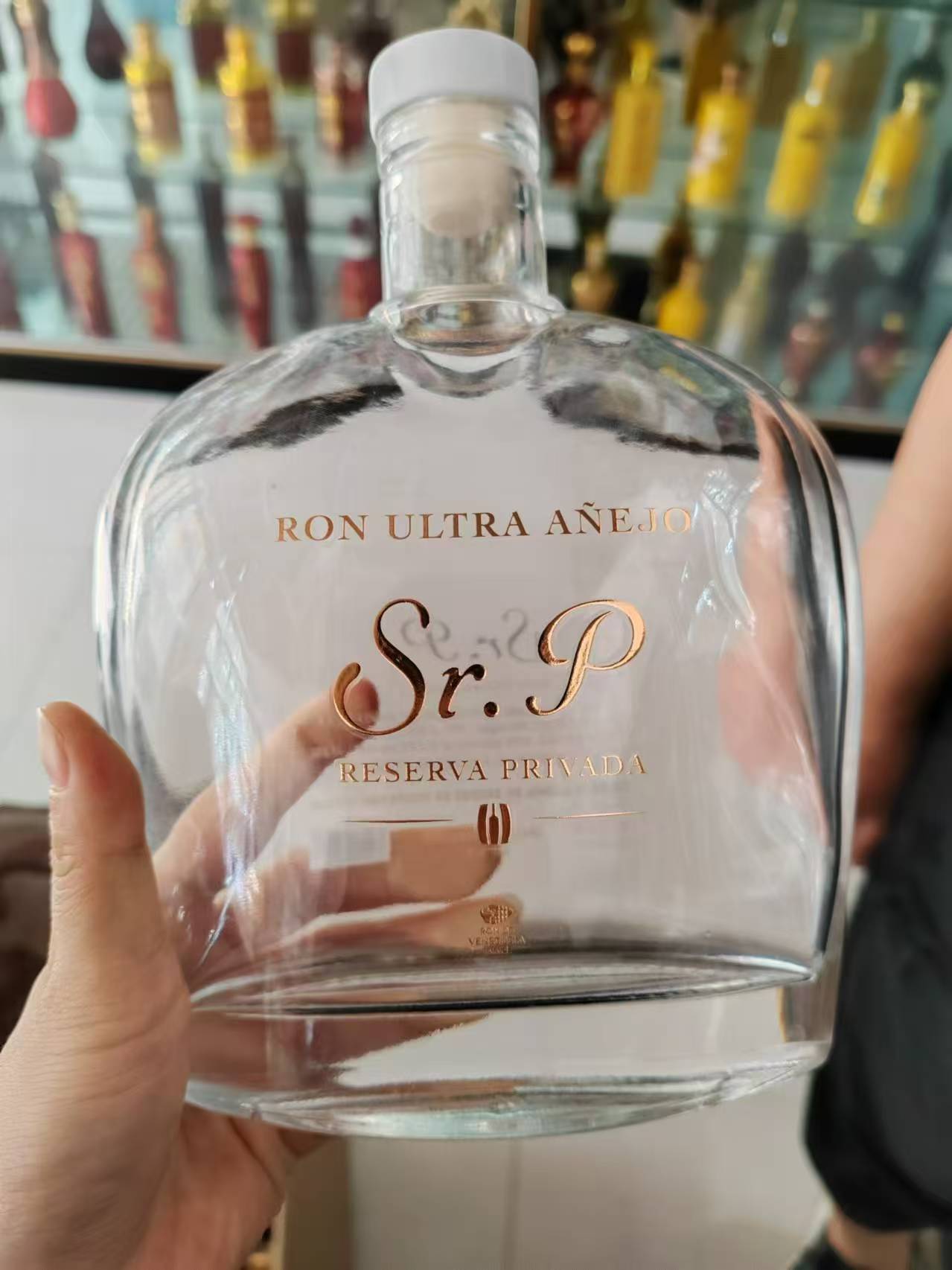 Gold water transfer decal on a premium rum bottle
