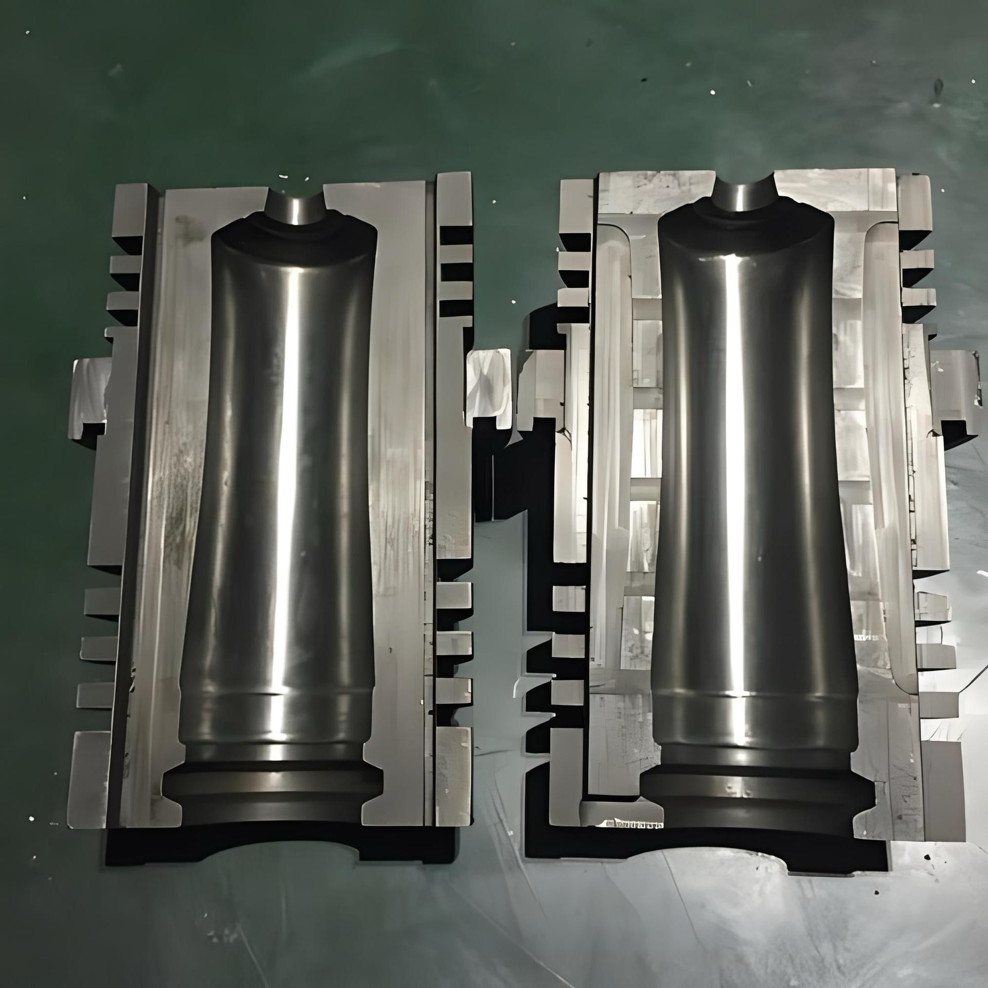 A polished pair of blow mould halves – the cavity is the exact negative of the bottle