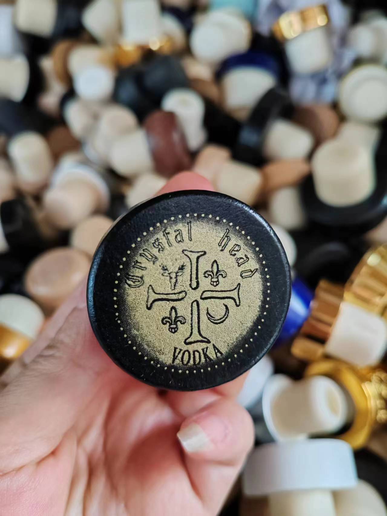 Black cap with gold engraved artwork for vodka branding