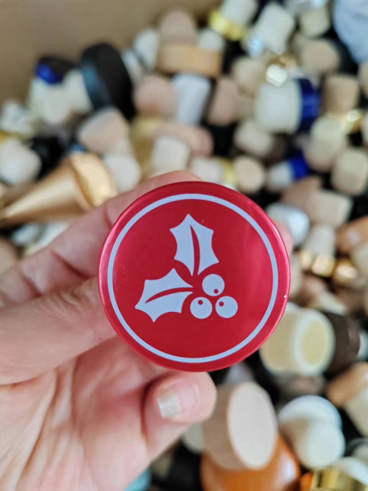 Red aluminum cap with white printed holly artwork